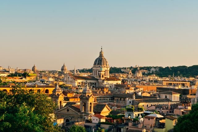 Home Capture the timeless beauty of Rome's skyline at sunset with its iconic domes and ancient buildings.