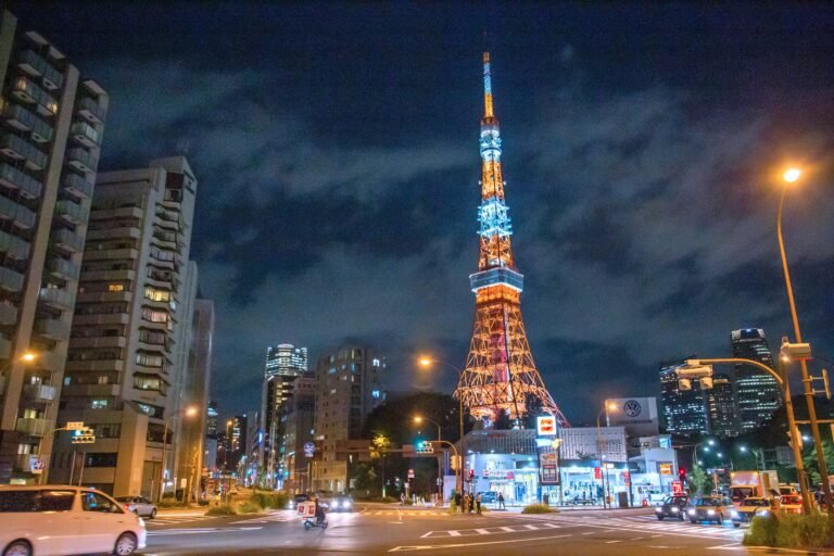 Stunning skyline of Minato City, Tokyo featuring the illuminated Tokyo Tower at night.